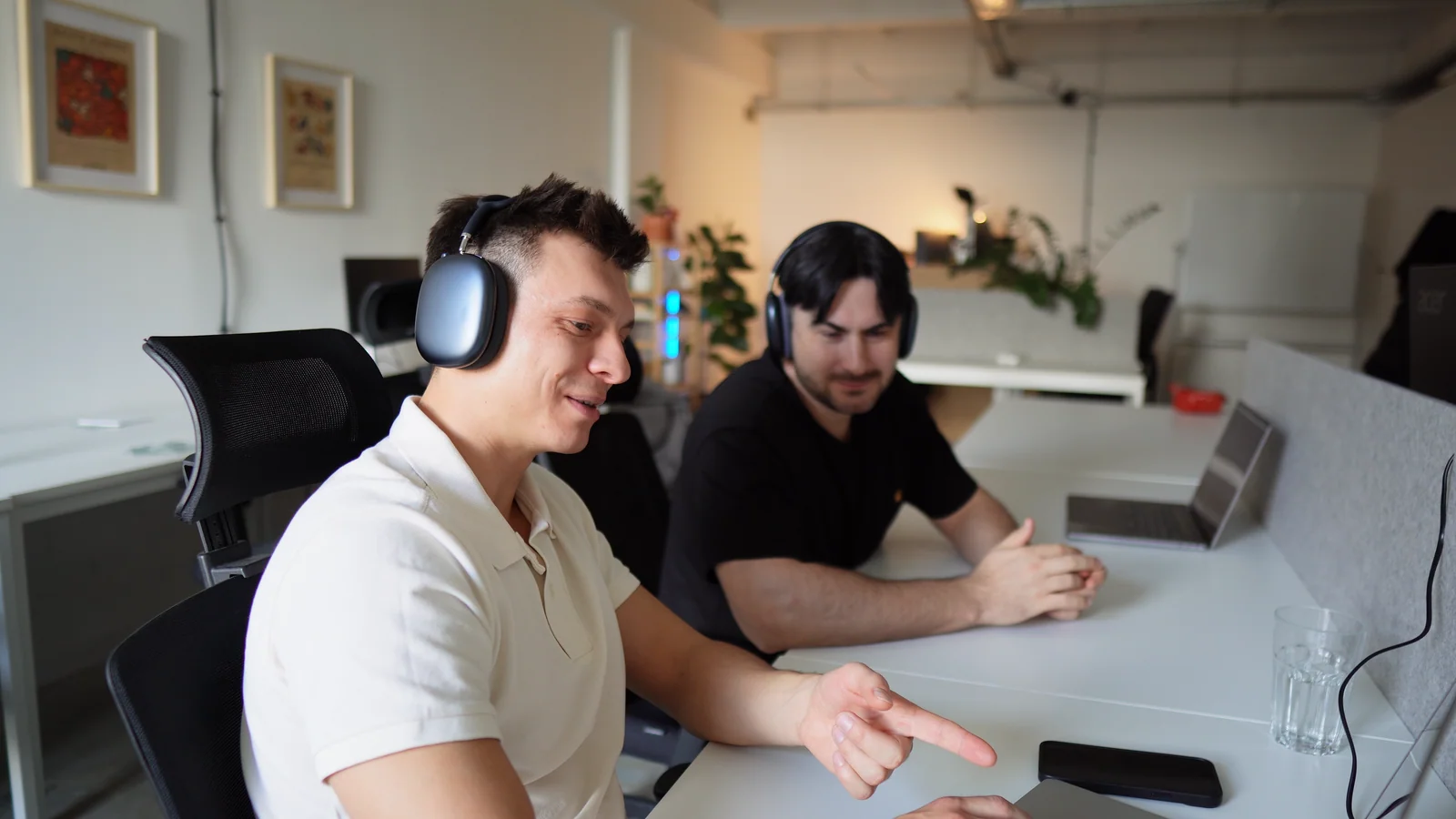 Bo and a colleague reviewing work together at their desks